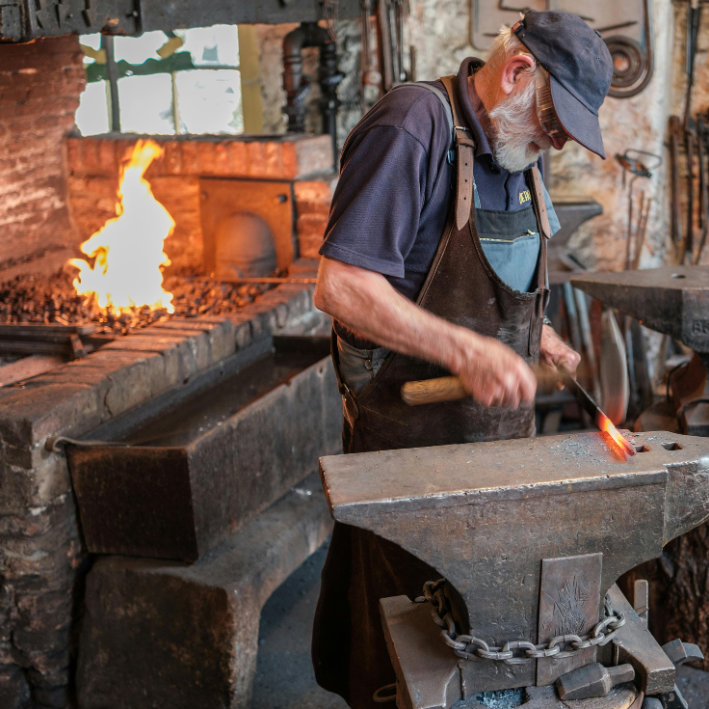 A blacksmith working on an anvil