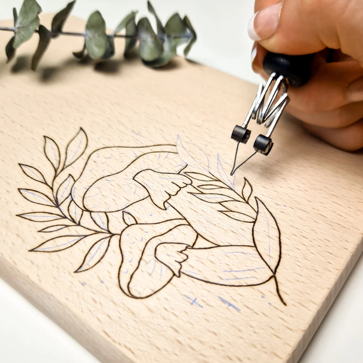 A wooden chopping board with pyrography design